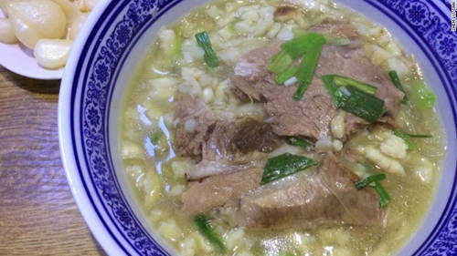 Vụn bánh mì chan canh thịt cừu (yangrou paomo) Nếu có hỏi đặc sản Tây An, người ta sẽ nói ngay cái tên yangrou paomo. Bánh mì dẹt cắt lát nhỏ được chan ngập nước canh thịt cừu luộc. Ăn một bát paomao là cách thư giãn độc đáo. Để bắt đầu bạn được phục vụ hai lát bánh mì trong một bát. Sau đó bạn phải xé bánh mì thành những miếng nhỏ như đậu nành. Việc này có thể mất thời gian nhưng người dân địa phương tin rằng bánh mì sẽ ngon hơn nếu khách khéo tay. Sau đó bạn trả lại bát và bánh mì cho quán để chan canh súp thịt cừu cùng bún gạo cho đến khi miếng bánh đã đẫm hương vị. Trên bát sẽ trải những lát thịt cừu hoặc thịt bò tùy chọn, thêm chút tỏi ngọt để trọn vẹn hương vị. Vụn bánh mì chan canh thịt cừu (yangrou paomo) Nếu có hỏi đặc sản Tây An, người ta sẽ nói ngay cái tên yangrou paomo. Bánh mì dẹt cắt lát nhỏ được chan ngập nước canh thịt cừu luộc. Ăn một bát paomao là cách thư giãn độc đáo. Để bắt đầu bạn được phục vụ hai lát bánh mì trong một bát. Sau đó bạn phải xé bánh mì thành những miếng nhỏ như đậu nành. Việc này có thể mất thời gian nhưng người dân địa phương tin rằng bánh mì sẽ ngon hơn nếu khách khéo tay. Sau đó bạn trả lại bát và bánh mì cho quán để chan canh súp thịt cừu cùng bún gạo cho đến khi miếng bánh đã đẫm hương vị. Trên bát sẽ trải những lát thịt cừu hoặc thịt bò tùy chọn, thêm chút tỏi ngọt để trọn vẹn hương vị.