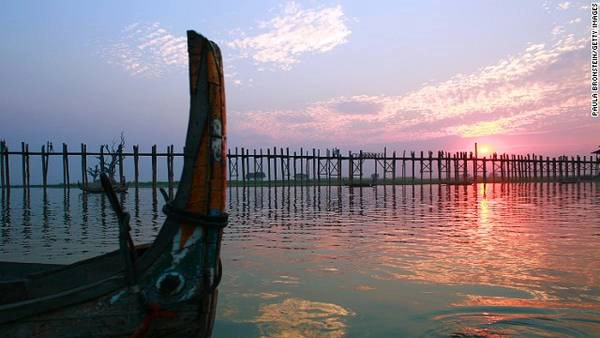 1. Cầu U Bein, Mandalay, Myanmar Mặt trời lặn ở cây cầu gỗ tếch dài nhất thế giới U Bein đẹp chẳng khác nào một bức tranh. Đây là cây cầu được đặt theo tên của cựu thị trưởng U Bein, dài 1,2km và bắt ngang qua hồ Taungthaman, Mandalay. Ban ngày, cầu U Bein luôn tập nấp người qua lại. Đến lúc chiều tà, không gian ở đây bình lặng và yên tĩnh hơn.  Di chuyển: Những chuyến bay từ các thành phố lớn ở Myanmar đến Mandalay hoạt động mỗi ngày. 