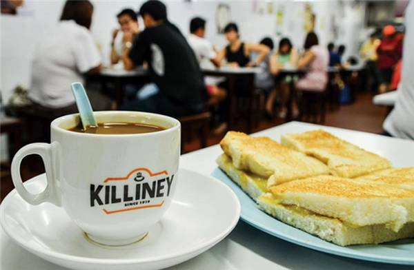 Bữa sáng với bánh mì nướng kaya và tách kopi tại một cửa hàng Killiney Kopitiam Bữa sáng với bánh mì nướng kaya và tách kopi tại một cửa hàng Killiney Kopitiam