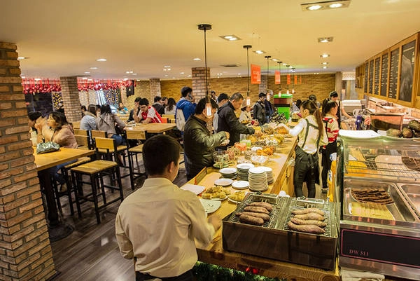 Ngay bên chỗ soát vé là những lò nướng giữ nhiệt độ cho bắp, khoai lang và bánh luôn được nóng thơm lừng cho du khách thưởng thức. Ảnh: dalat