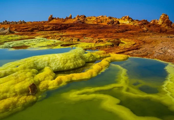 Được hình thành do sự va chạm của những mảng kiến tạo ở biên giới Ethiopia, Eritrea và Djibouti, vùng trũng Danakil sở hữu kỳ quan địa chất tuyệt đẹp. Nơi đây có những cánh đồng thủy nhiệt đầy màu sắc, chảo muối khổng lồ và hồ nước nóng đầy hóa chất bên dưới là dòng dung nham ngầm sôi sục. Ảnh: The Atlantic.