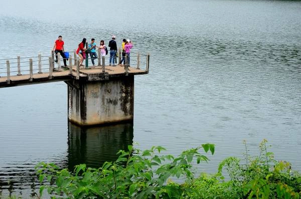 Các bạn trẻ đứng trên van lấy nước vào cánh đồng để ngắm toàn cảnh hồ. Các bạn trẻ đứng trên van lấy nước vào cánh đồng để ngắm toàn cảnh hồ.