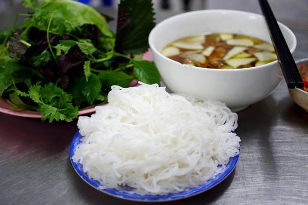 Hai thành phần không thể thiếu có của món bún chả Hà Nội chính là bún và rau sống. Bún của quán tươi sạch, ăn vào sẽ thấy độ dai mềm, đậm đà hơn khi thưởng thức cùng nước chấm chua ngọt và chả, thịt nướng còn nóng hổi. Thực khách cũng có thể gọi thêm bún với giá 5.000 đồng mỗi đĩa nếu ăn chưa "đã". Ngoài ra các loại rau sống như xà lách, kinh giới, tía tô, mùi tàu, rau mùi... sẽ góp thêm hương vị, giúp thực khách bớt cảm giác ngậy của chả, thịt và còn tăng tính mát cho món ăn. Ảnh: Hương Chi Hai thành phần không thể thiếu có của món bún chả Hà Nội chính là bún và rau sống. Bún của quán tươi sạch, ăn vào sẽ thấy độ dai mềm, đậm đà hơn khi thưởng thức cùng nước chấm chua ngọt và chả, thịt nướng còn nóng hổi. Thực khách cũng có thể gọi thêm bún với giá 5.000 đồng mỗi đĩa nếu ăn chưa "đã". Ngoài ra các loại rau sống như xà lách, kinh giới, tía tô, mùi tàu, rau mùi... sẽ góp thêm hương vị, giúp thực khách bớt cảm giác ngậy của chả, thịt và còn tăng tính mát cho món ăn. Ảnh: Hương Chi