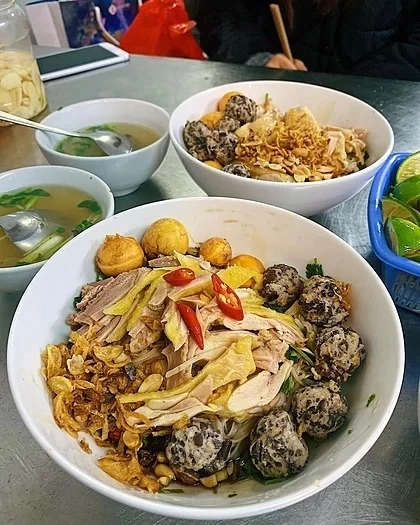 Phở gà Nguyệt, Phủ Doãn  Mở cửa từ 18 giờ tối đến 2 giờ sáng hôm sau, quán là địa chỉ ẩm thực quen thuộc của các bạn trẻ với món như phở trộn, phở nước, mì và miến. Thịt gà ở quán được nhiều thực khách đánh giá là giòn, dai và có da vàng bóng. Ăn kèm với phở trộn còn có hành khô, lạc, mọc, rau thơm và trứng gà non. Mỗi bát ở đây có giá dao động từ 35.000 đến 55.000 đồng tùy theo yêu cầu phần thịt đùi hay lườn. Ảnh: Instagram/Mini Cindy.