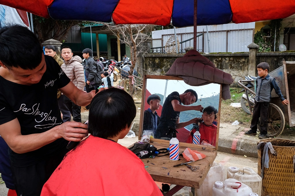 Tới chợ phiên, các du khách không thể quên “làm đẹp”. Trong ảnh là một thanh niên đang được đi cắt tóc, "tân trang" lại dịp đầu xuân.