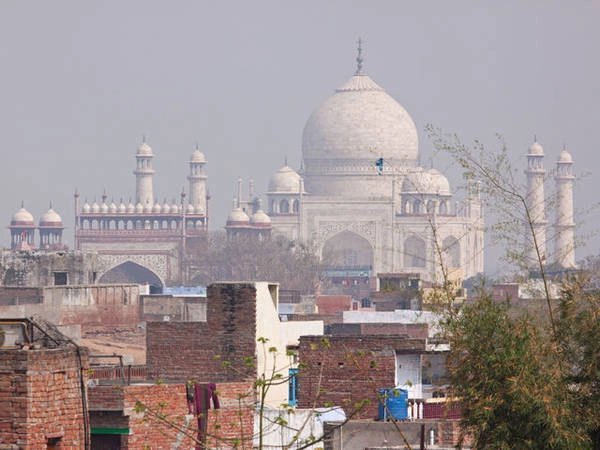  Nhưng Taj Mahal có thể sẽ khiến bạn thất vọng khi biết rằng khi chụp từ phía xa, ở một góc nhìn khác, xuyên qua khu dân cư với những bức tường gạch lố nhố, nơi đây chẳng hề long lanh như ảnh thường thấy.