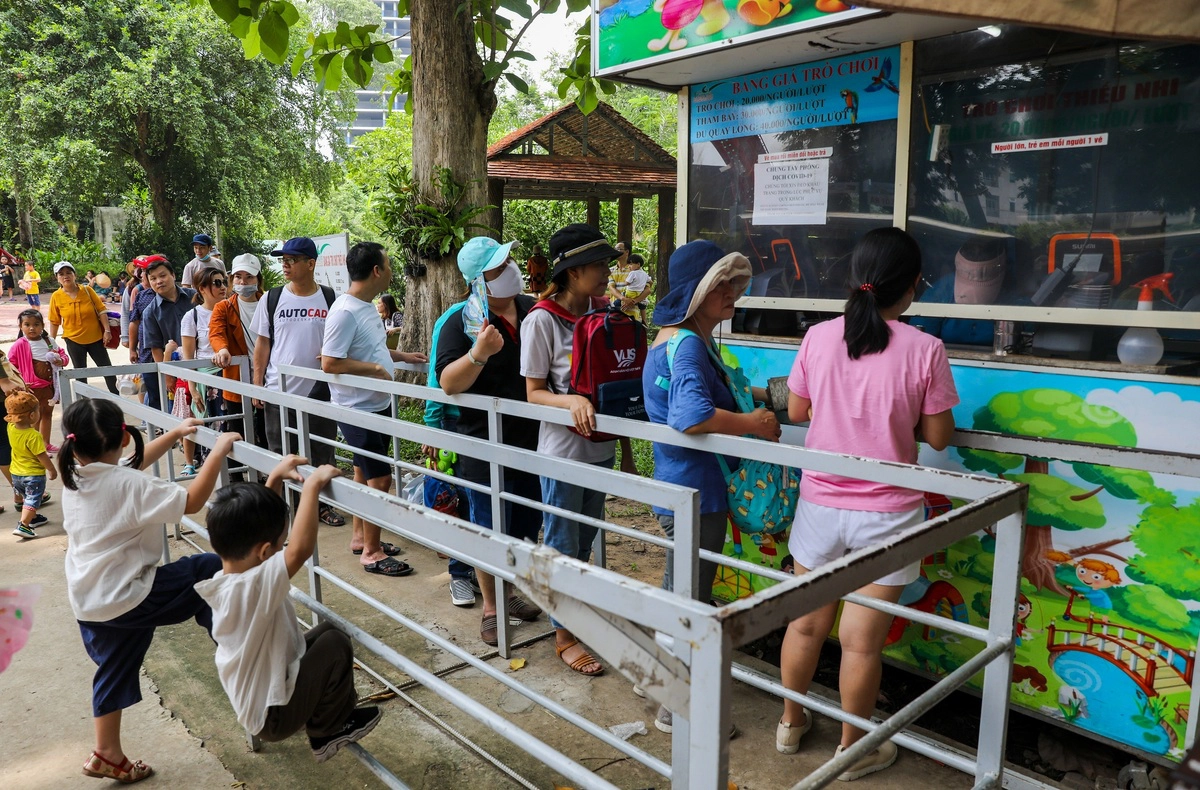 Các quầy bán vé trò chơi thiếu nhi như đu quay, tàu lượn, xe điện đụng... đều đông đúc, dòng người xếp hàng dài chờ mua vé.