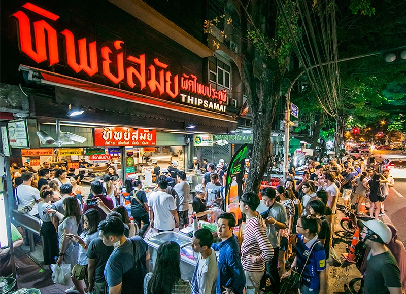 Thipsamai nằm tại quận Pha Nakorn, cách China town của thủ đô Bangkok không xa, được trang Michelin giới thiệu là một trong những tiệm ăn đường phố đáng chú ý nhất ở Thái Lan vào năm 2017. Quán bắt đầu bán từ năm 1966, phục vụ món pad Thái truyền thống và mỗi ngày đón cả nghìn lượt khách đến ăn. Thipsamai nằm tại quận Pha Nakorn, cách China town của thủ đô Bangkok không xa, được trang Michelin giới thiệu là một trong những tiệm ăn đường phố đáng chú ý nhất ở Thái Lan vào năm 2017. Quán bắt đầu bán từ năm 1966, phục vụ món pad Thái truyền thống và mỗi ngày đón cả nghìn lượt khách đến ăn.